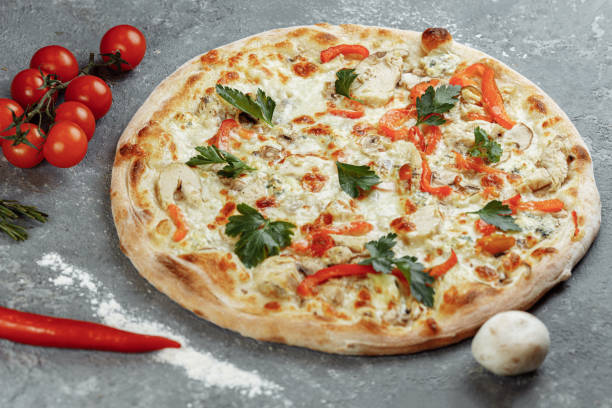 istock Chicken-blue pizza with tomato, mozzarella and Dor Blue cheeses on gray background 1283758664