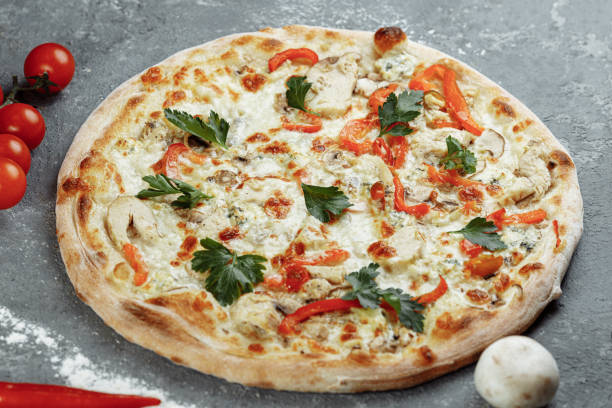 istock Chicken-blue pizza with tomato, mozzarella and Dor Blue cheeses on gray background 1283758681