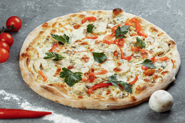 istock Chicken-blue pizza with tomato, mozzarella and Dor Blue cheeses on gray background 1283758686