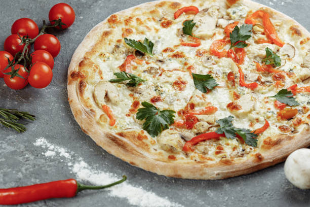 istock Chicken-blue pizza with tomato, mozzarella and Dor Blue cheeses on gray background 1283758695