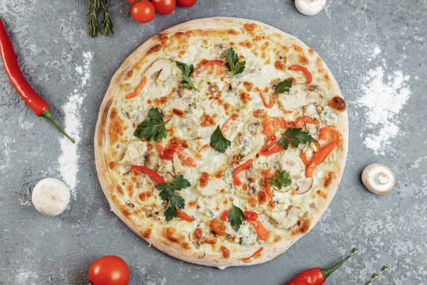 istock Chicken-blue pizza with tomato, mozzarella and Dor Blue cheeses on gray background 1283758702