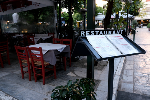 Empty chairs and tables of a restaurant are seen in downtown Athens at midnight in Athens, Greece, on October 31, 2020.