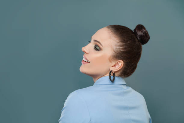 istock Happy woman brunette looking aside on blue background 1283759064