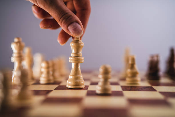 istock Unrecognizable Person Moving Chess Piece On Chess Board 1283759748