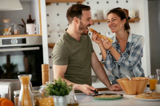 istock Husband and wife making pancakes at home. 1283760015
