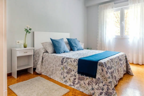 istock Double bedroom decorated with quilt and curtains 1283760888