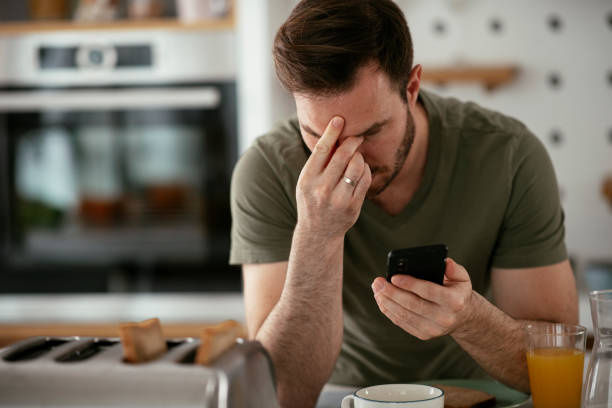 istock Young man eating breakfast and reading the news online. 1283761231