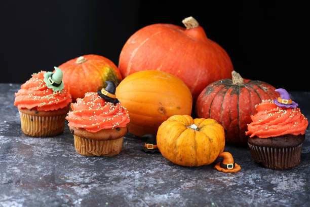 istock halloween cupcake and pumpkin on a dark background. sweets with cupcakes for the celebration of spooky Halloween. 1283761238