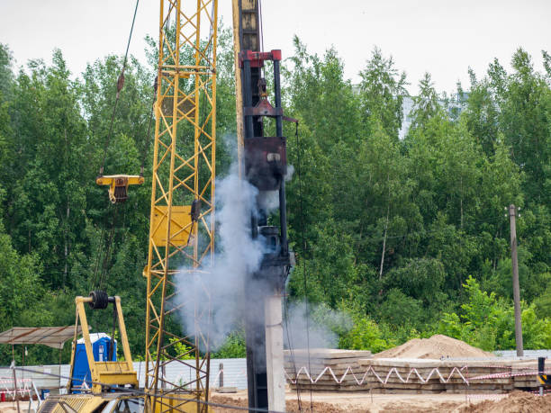 istock Drop hammer while working on driving piles, diesel hammer strikes a series of blows on a concrete pile, foundation construction using iron concrete 1283765893