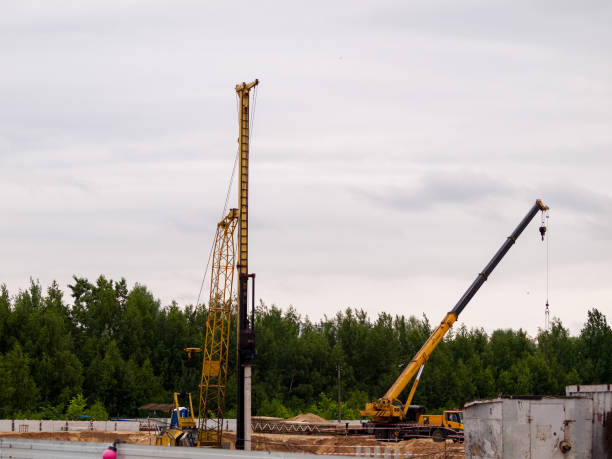 istock Pile driver, industrial scale piledriver, diesel impact hammer hammers piles when building the foundation 1283765926