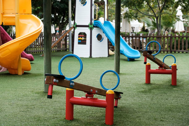 istock Empty swings on kindergarten playground. Unattended slide and swing set during coronavirus outbreak. 1283766031