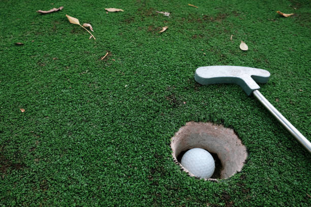 istock Setting goals and winning lifestyle concept. Playing mini golf on artificial green grass outdoors. 1283766151