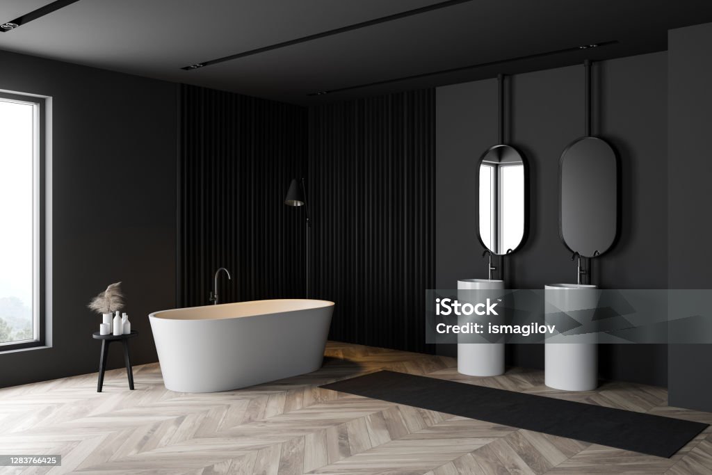 Dark gray bathroom corner, tub and sink Corner of stylish bathroom with dark gray walls, wooden floor, comfortable bathtub, double sink and oval mirrors. 3d rendering Apartment Stock Photo