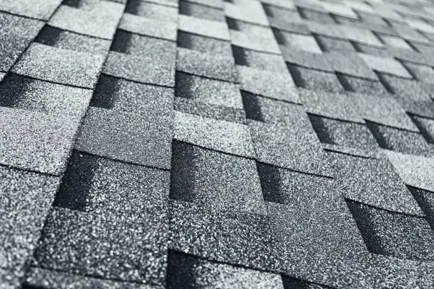 Photo of shingles flat polymeric roof-tiles background, close-up view