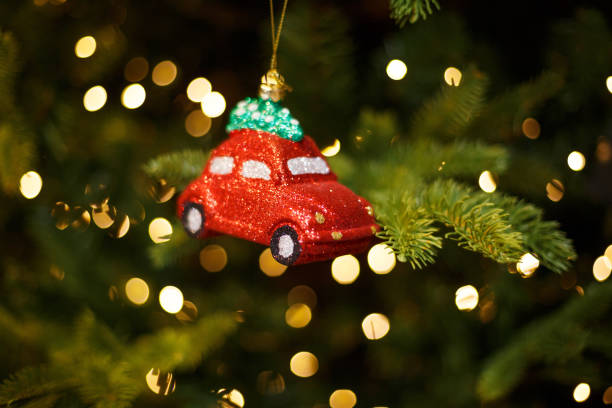 istock Toy shiny red car on the Christmas tree, holiday decor 1283769406