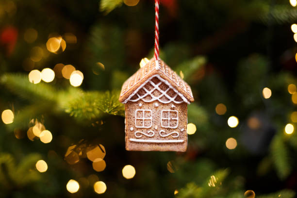 istock Toy gingerbread house hanging on the Christmas tree, holiday decor 1283769421