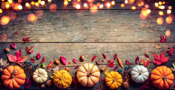 istock Thanksgiving Board - Wooden Table With Pumpkins And Lights 1283769462