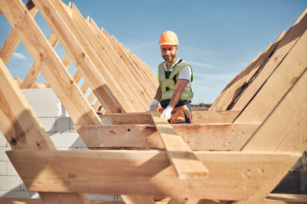 istock Concentrated construction site worker using wood to build a roof 1283773594