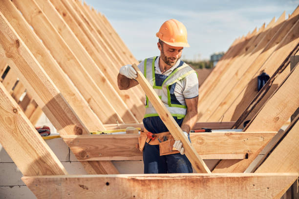 istock Focused builder is adjusting a wooden bar to a roof carcass 1283773596