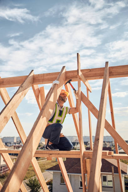 istock Builder in charge of a hammer-work at a construction site 1283773613