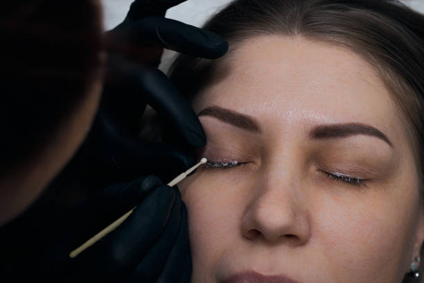 istock Permanent eyebrow makeup procedure. Eyebrow tattooing, process. The use of tools by a master for permanent eyebrow makeup. 1283776530