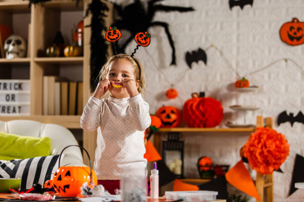 istock Little girl enjoying Halloween candy 1283776677