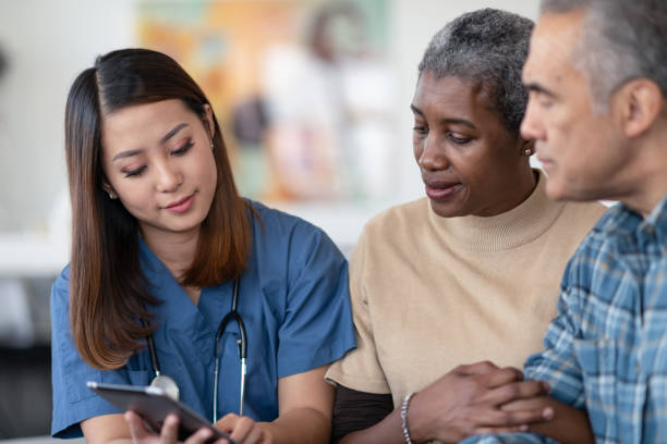 istock Visiting nurse meets with senior couple 1283776729