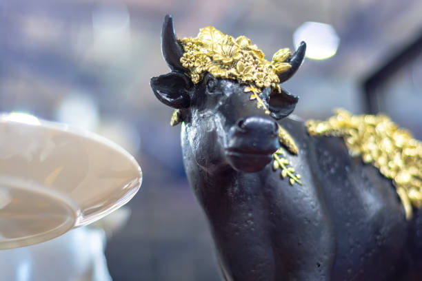 istock Black bull figurine with golden decorative elements 1283777047