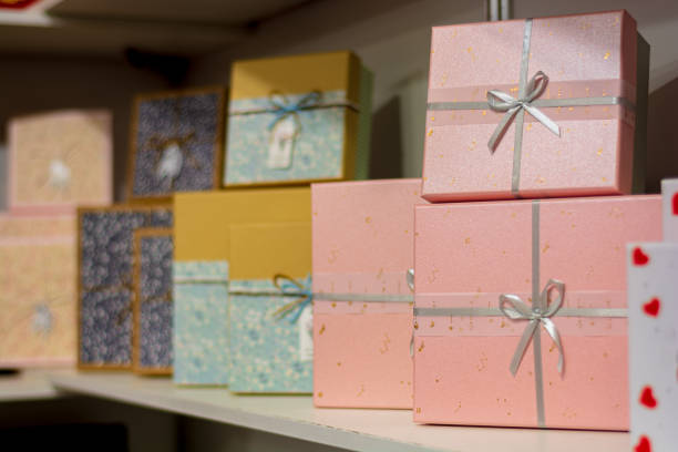 istock Square gift boxes tied with ribbon on shelves 1283777104
