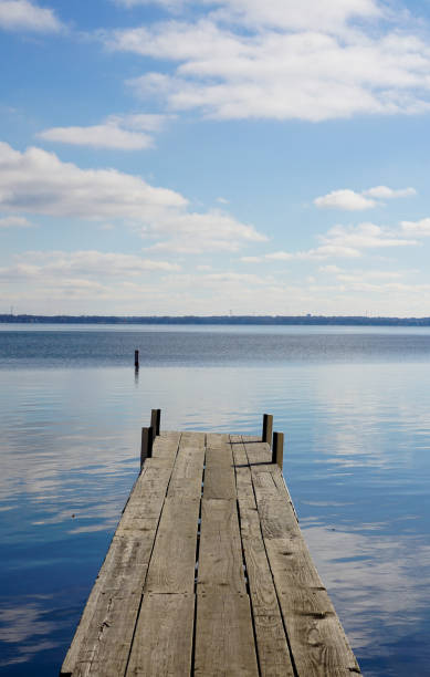 istock Beautiful sky reflected in calm lake with wooden dock 1283780045
