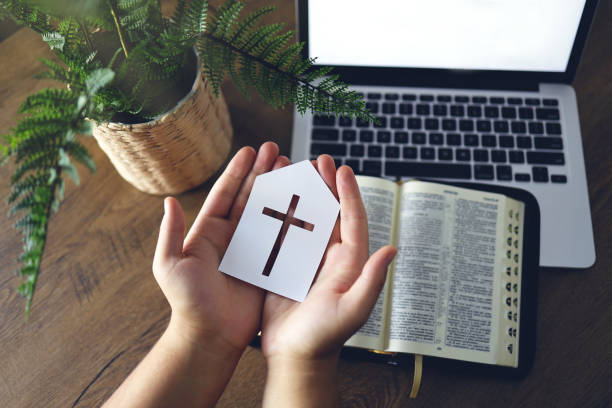 Photo of Man praying by faith with computer laptop, Church services online concept, Online church at home concept