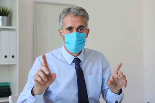 istock Handsome businessman with medical mask. 1283783586