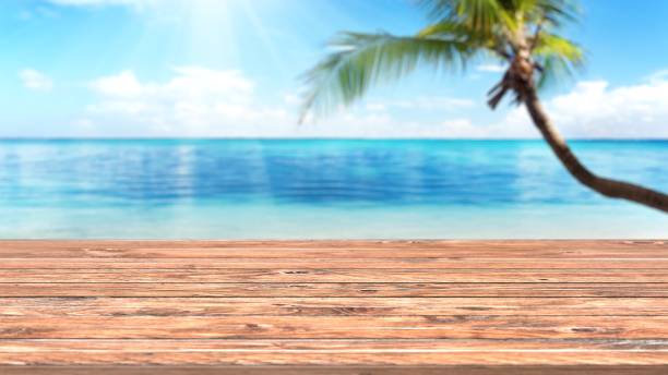 istock Empty wooden planks with blur beach on background, can be used for product placement. 3D render 1283785555