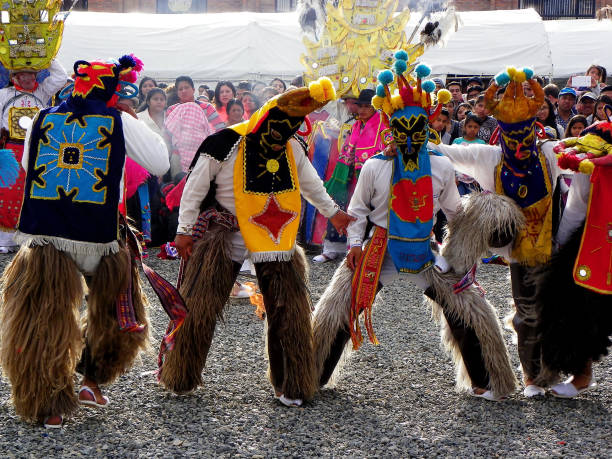 Dancers as characters of Inti Raymi called Diablo Huma, Ecuador Cuenca, Ecuador - April 12, 2016: Dancers dressed as characters of Inti Raymi celebration called Diablo Huma (Devil) at the annual parade for day foundation of Cuenca, Ecuador inti raymi stock pictures, royalty-free photos & images