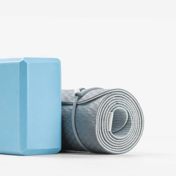 istock Rolled yoga mat and yoga block or brick 1283796695