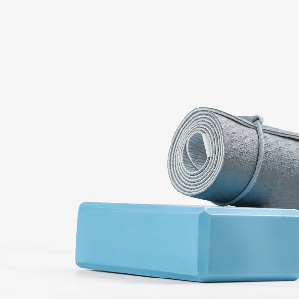 istock Rolled yoga mat and yoga block or brick 1283796702