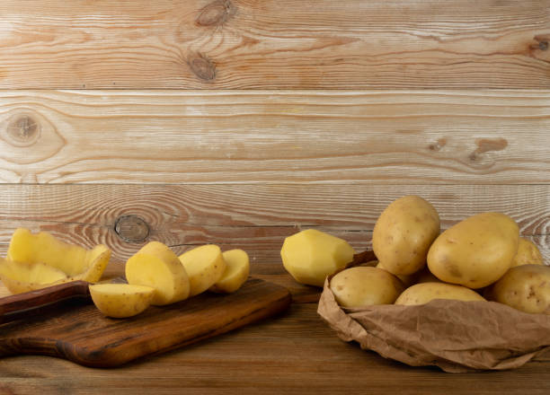 istock Raw Chopped Potato on Wooden Cutting Board Background 1283796741