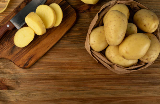 istock Raw Chopped Potato on Wooden Cutting Board Background 1283796793
