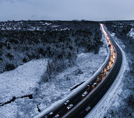 Aerial drone view of highway traffic during the fist snowfall of the season.