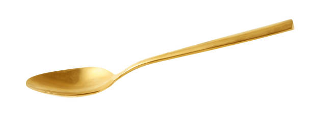 golden spoon isolated on white background stock photo