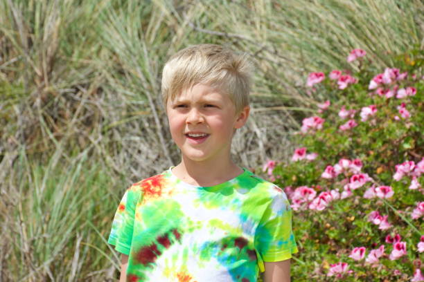 istock Child Wearing Tie Dye T-shirt at Beach 1283803696