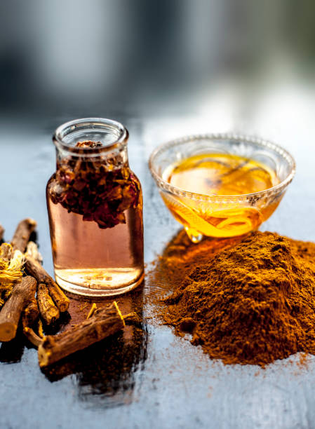 istock Quick Healing wound paste consisting of natural ayurvedic herbs i.e. Revand chini well mixed with rose water and honey. Shot of revand chini roots, powder, rose water and honey on a wooden surface.; 1283804754
