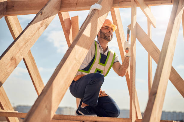 istock Joyous construction site worker with hammer building a roof carcass 1283804834