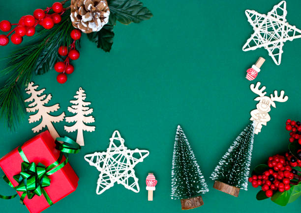 istock Christmas modern composition. gift, fir branches, red berries, Xmas decorations green background. Christmas, New Year, winter concept. Flat lay, top view, copy space. 1283809783