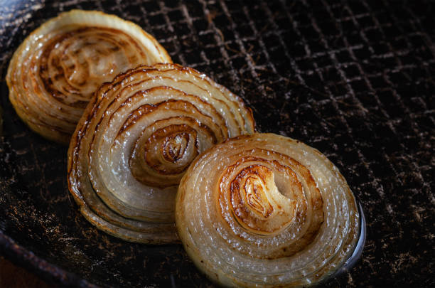 istock Fried onions with rings in oil in pan. 1283809830