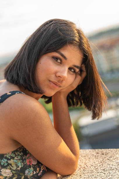 istock Beautiful young woman at balcony 1283811815