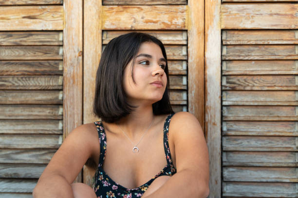 istock Cool young woman leaning on blinds 1283811820