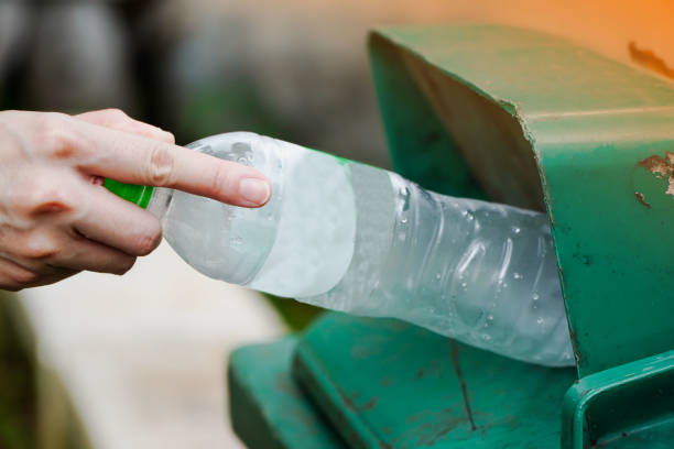 istock Woman hand throwing away plastic bottles in nature Environmental damage from plastic waste, environmental conservation 1283811905