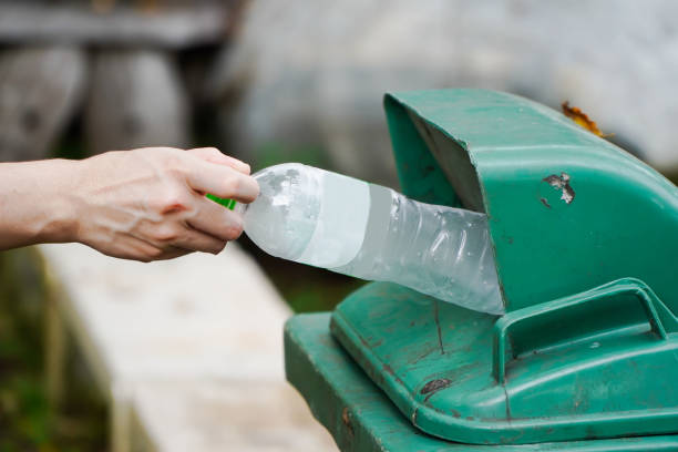 istock Woman hand throwing away plastic bottles in nature Environmental damage from plastic waste, environmental conservation 1283811938