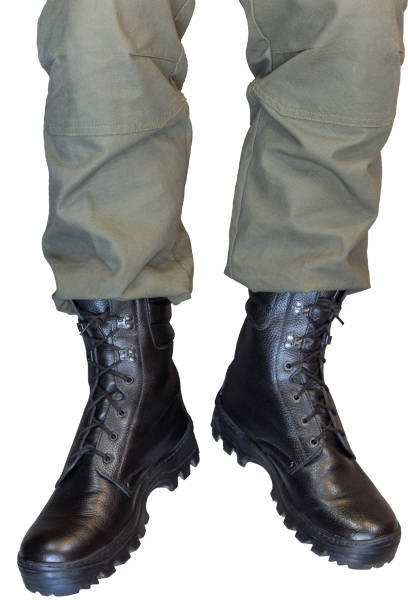 istock Legs in army khaki pants and military boots 1283812870